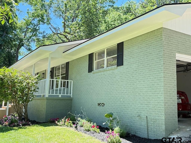 1113 Swanson Dr, Palestine, TX 75801 - view of property exterior with brick siding, a lawn, and a porch