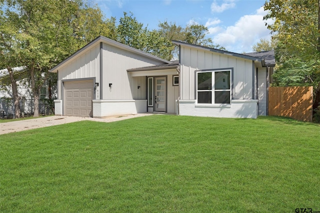 view of front of home with a garage and a front lawn