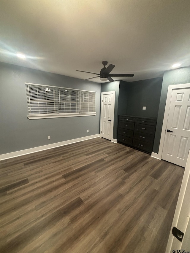 unfurnished bedroom with dark hardwood / wood-style flooring and ceiling fan