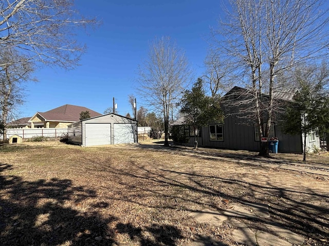 view of yard with a garage and an outdoor structure