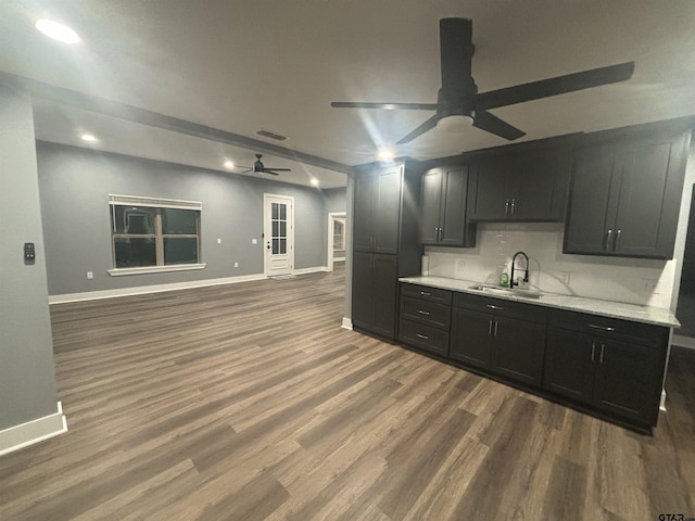 kitchen with ceiling fan, sink, backsplash, and dark hardwood / wood-style flooring