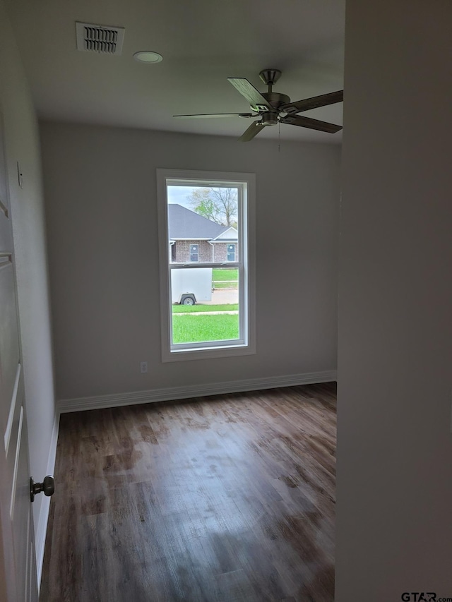 spare room featuring hardwood / wood-style floors and ceiling fan