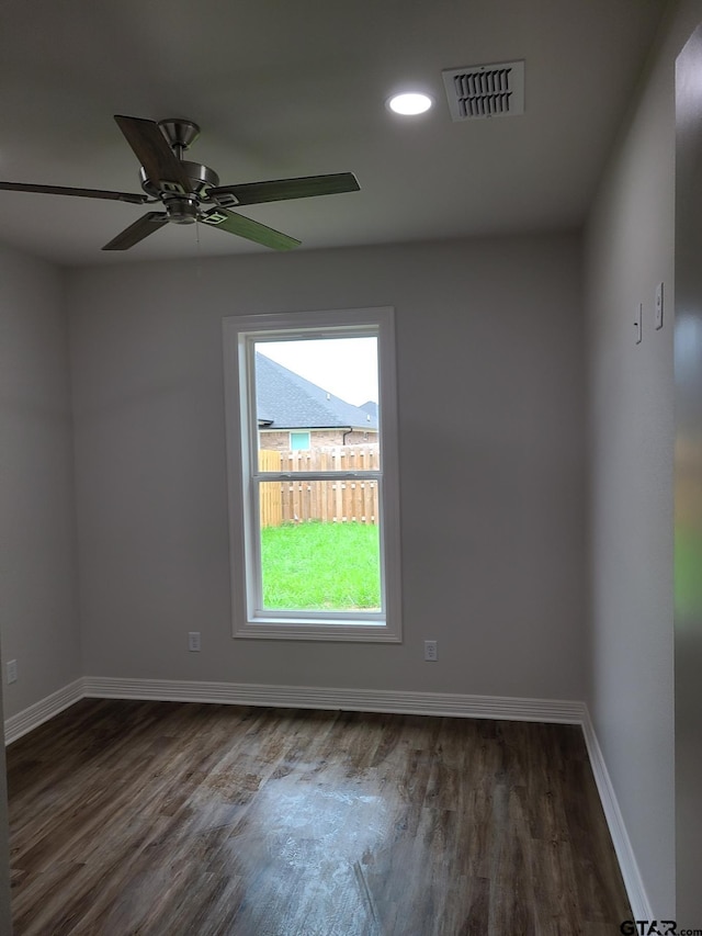 spare room with ceiling fan and dark hardwood / wood-style flooring