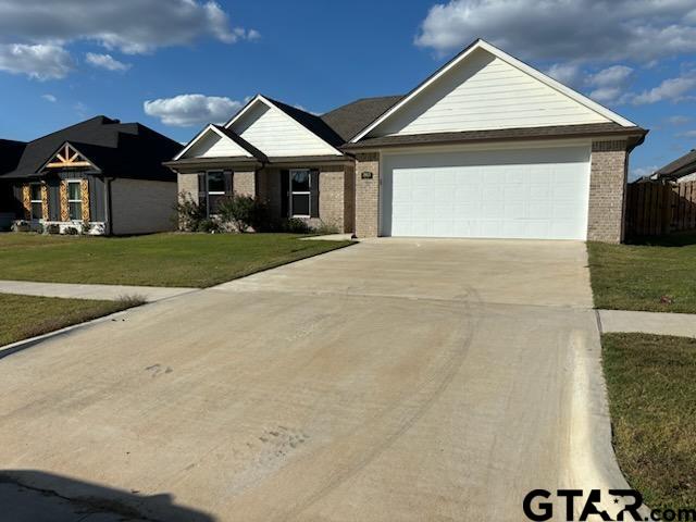 view of front of home featuring a garage and a front lawn