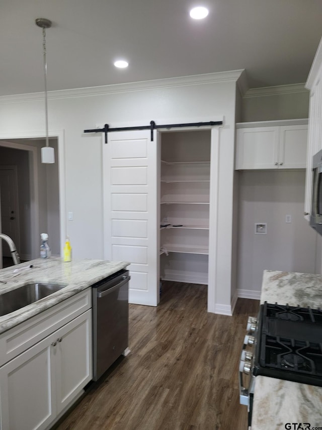 kitchen with white cabinets, dark wood-type flooring, stainless steel dishwasher, and decorative light fixtures