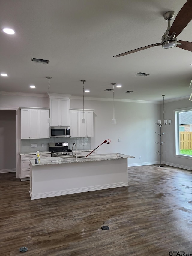 kitchen featuring white cabinetry, appliances with stainless steel finishes, a center island with sink, and dark hardwood / wood-style floors