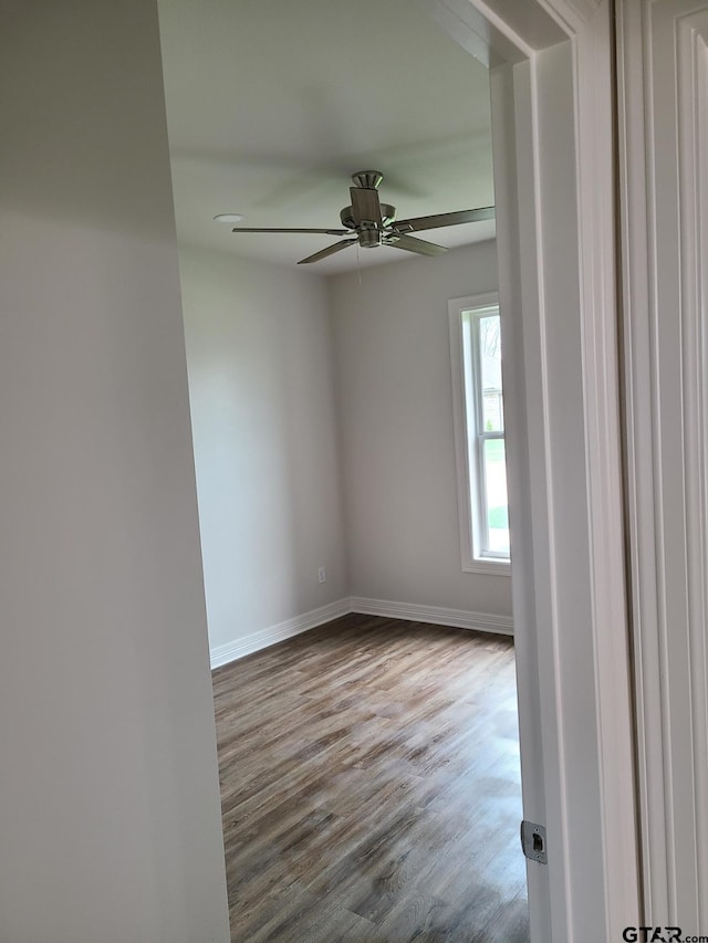 spare room featuring wood-type flooring and ceiling fan