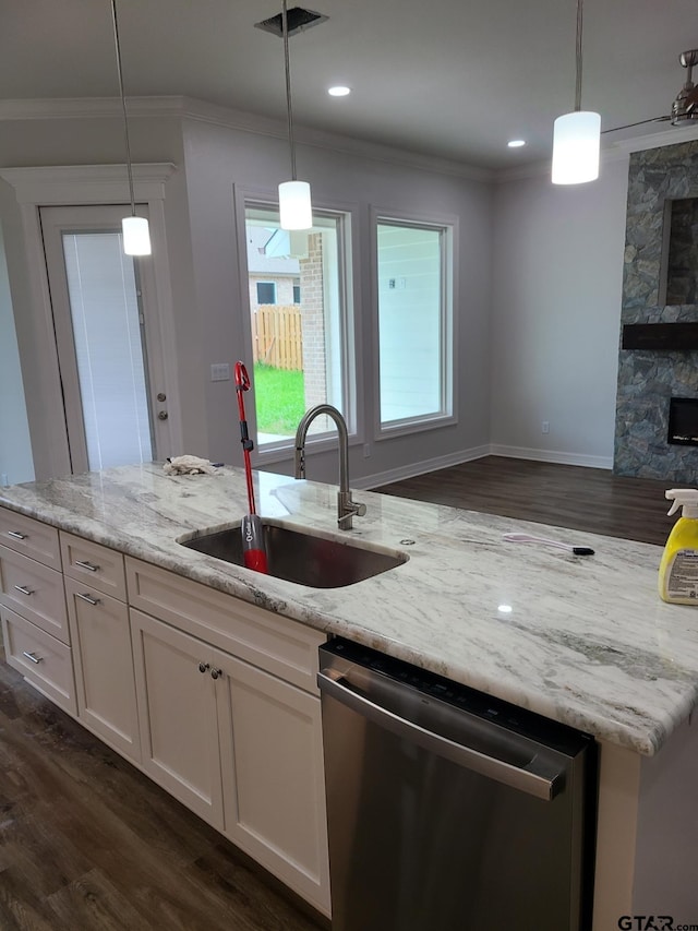 kitchen with dishwasher, pendant lighting, light stone counters, and white cabinets