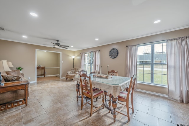 dining room with ceiling fan, a healthy amount of sunlight, and crown molding