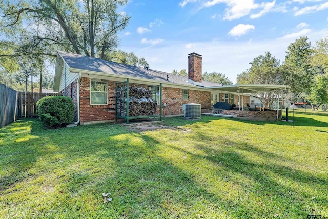 back of house with central air condition unit and a lawn