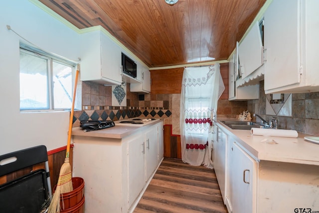 kitchen with light countertops, decorative backsplash, and white cabinets