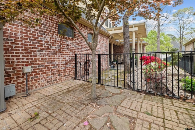 view of patio with a gate and fence