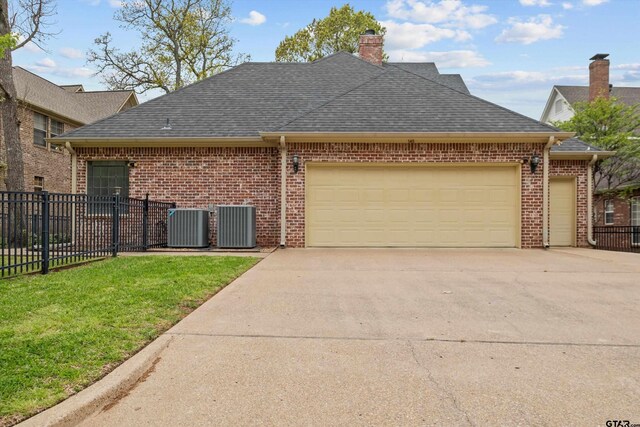 view of front of house with brick siding, driveway, fence, and an attached garage