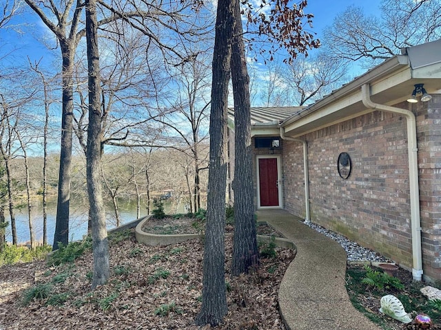 doorway to property with a water view