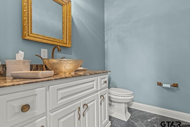 bathroom with toilet and vanity