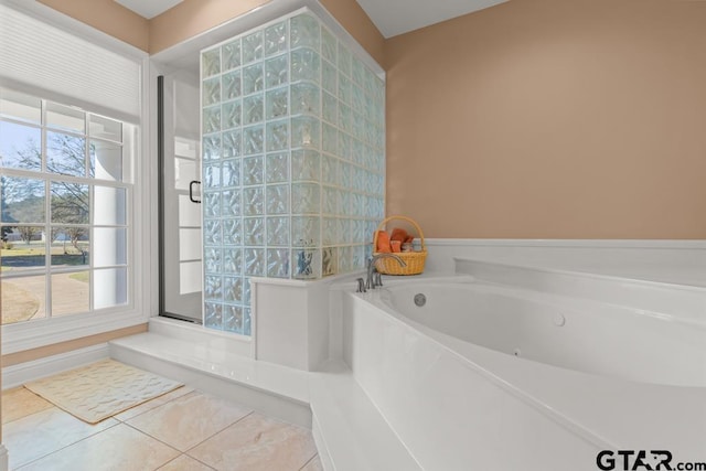 bathroom with a washtub and tile patterned floors