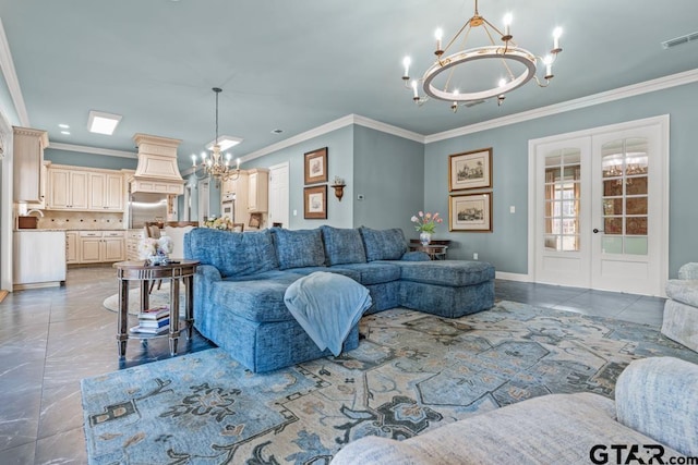 living room with ornamental molding, a chandelier, and french doors