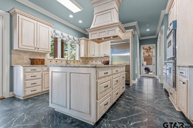 kitchen with cream cabinets, crown molding, stainless steel double oven, and decorative backsplash