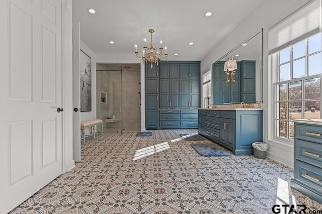 bathroom with a chandelier and vanity