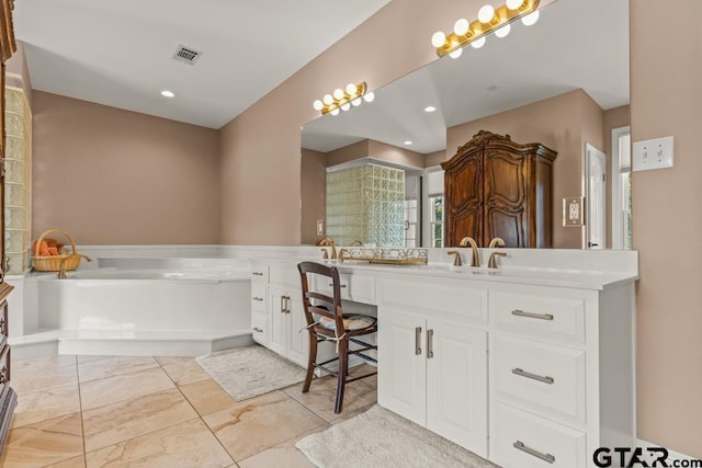 bathroom with a tub to relax in and vanity