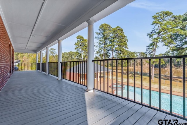 deck featuring a fenced in pool