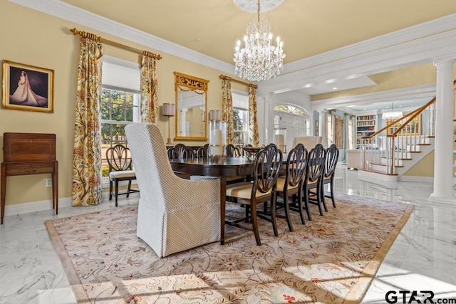 dining space featuring crown molding, ornate columns, and a notable chandelier