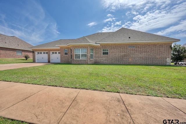 ranch-style home with a garage and a front lawn