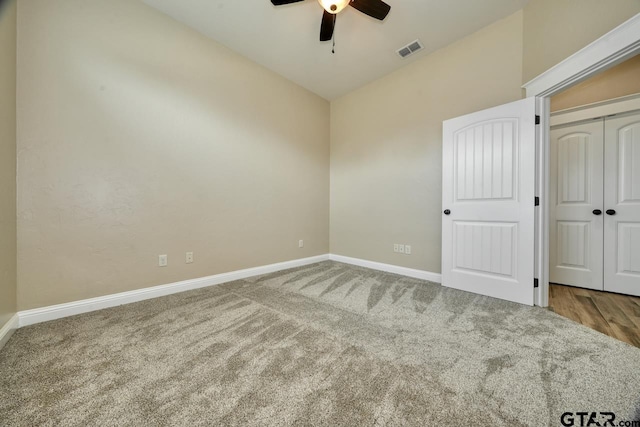 unfurnished bedroom with carpet flooring, a closet, ceiling fan, and lofted ceiling