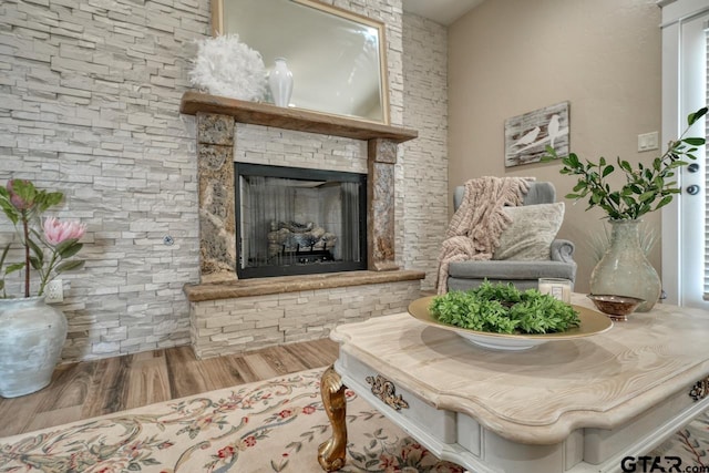 living area featuring hardwood / wood-style floors and a fireplace