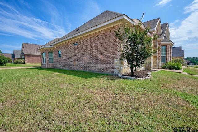 view of side of property with a lawn