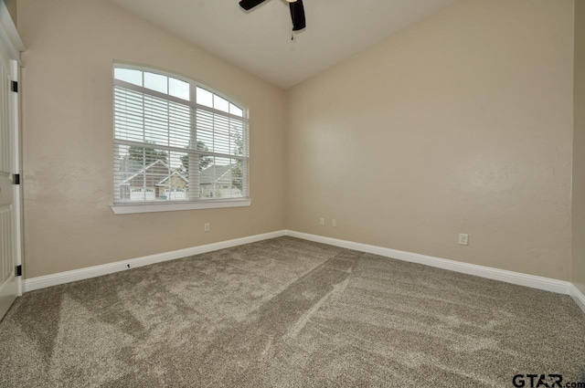 spare room with ceiling fan, lofted ceiling, and carpet floors