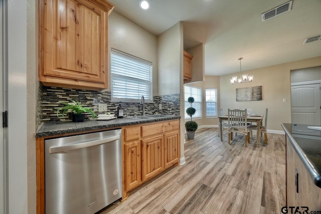 kitchen featuring dishwasher, sink, hanging light fixtures, a notable chandelier, and light wood-type flooring