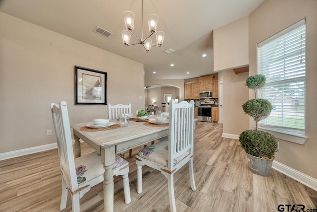 dining room featuring a chandelier and light hardwood / wood-style floors