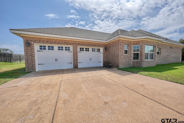 view of front of home with a front lawn and a garage