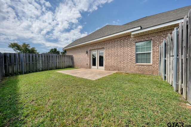 back of property featuring a lawn and a patio area