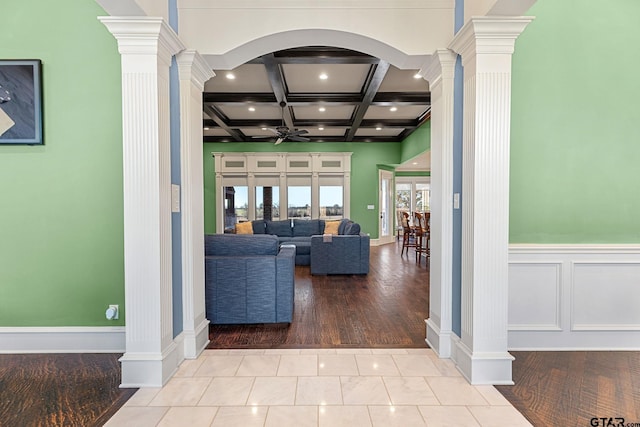 living room with french doors, tile patterned floors, coffered ceiling, ornate columns, and beam ceiling