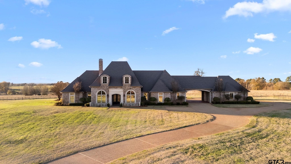 french provincial home featuring a front lawn