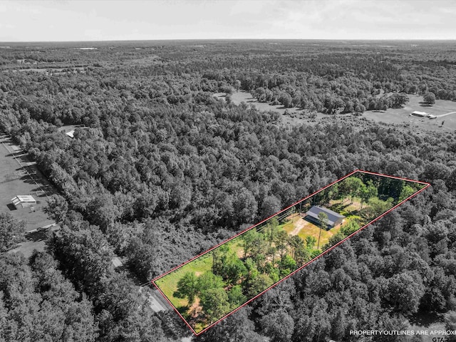 view of property location featuring a forest and property parcel outlined