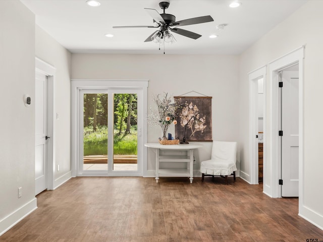 sitting room with wood finished floors, a ceiling fan, recessed lighting, and baseboards