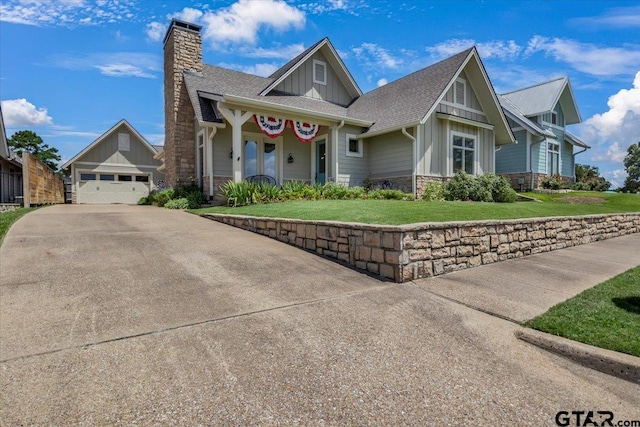 14621 Twin Pine Ln, Lindale, TX 75771 - craftsman house featuring board and batten siding, stone siding, a front lawn, a chimney, and concrete driveway