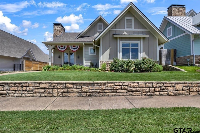 14621 Twin Pine Ln, Lindale, TX 75771 - view of front of home with a chimney, board and batten siding, and stone siding