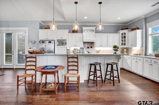 14621 Twin Pine Ln, Lindale, TX 75771 - kitchen featuring appliances with stainless steel finishes, white cabinetry, tasteful backsplash, glass insert cabinets, and dark wood-type flooring