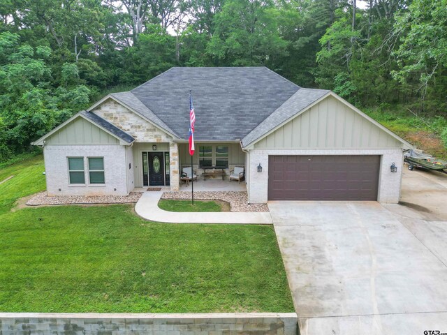 17294 Hidden Valley Ln, Flint, TX 75762 - single story home featuring board and batten siding, a garage, a front yard, concrete driveway, and roof with shingles