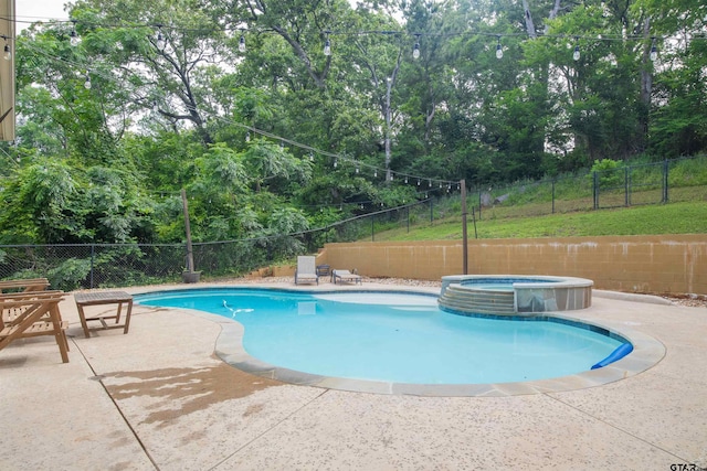 17294 Hidden Valley Ln, Flint, TX 75762 - view of swimming pool featuring a fenced backyard, a pool with connected hot tub, a patio area, and view of wooded area