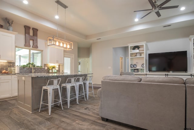 17294 Hidden Valley Ln, Flint, TX 75762 - living area with recessed lighting, ceiling fan, a tray ceiling, and dark wood-type flooring