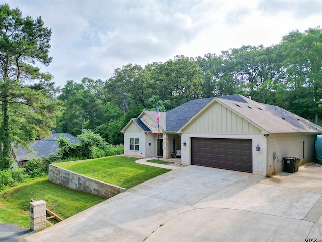 17294 Hidden Valley Ln, Flint, TX 75762 - view of front facade featuring board and batten siding, an attached garage, a front yard, concrete driveway, and brick siding