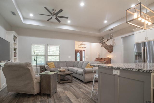17294 Hidden Valley Ln, Flint, TX 75762 - living area featuring a raised ceiling, dark wood-style flooring, ceiling fan, recessed lighting, and a chandelier