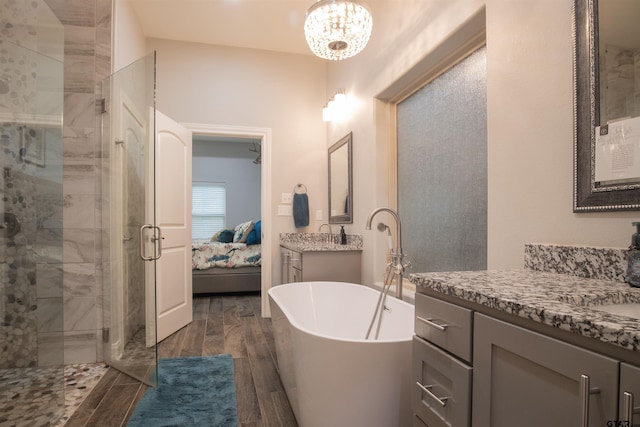 17294 Hidden Valley Ln, Flint, TX 75762 - full bath featuring a stall shower, ensuite bathroom, a freestanding tub, wood finished floors, and two vanities