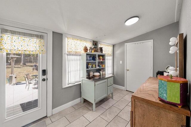 505 S Boyd St, Lindale, TX 75771 - doorway to outside with lofted ceiling, light tile patterned floors, and baseboards