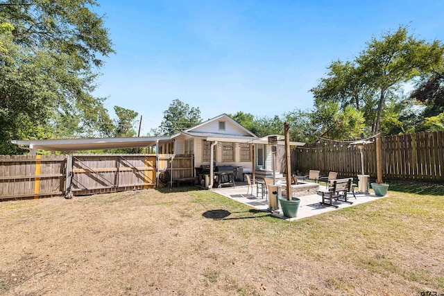 505 S Boyd St, Lindale, TX 75771 - back of property with a patio, an outdoor structure, a fenced backyard, and a lawn